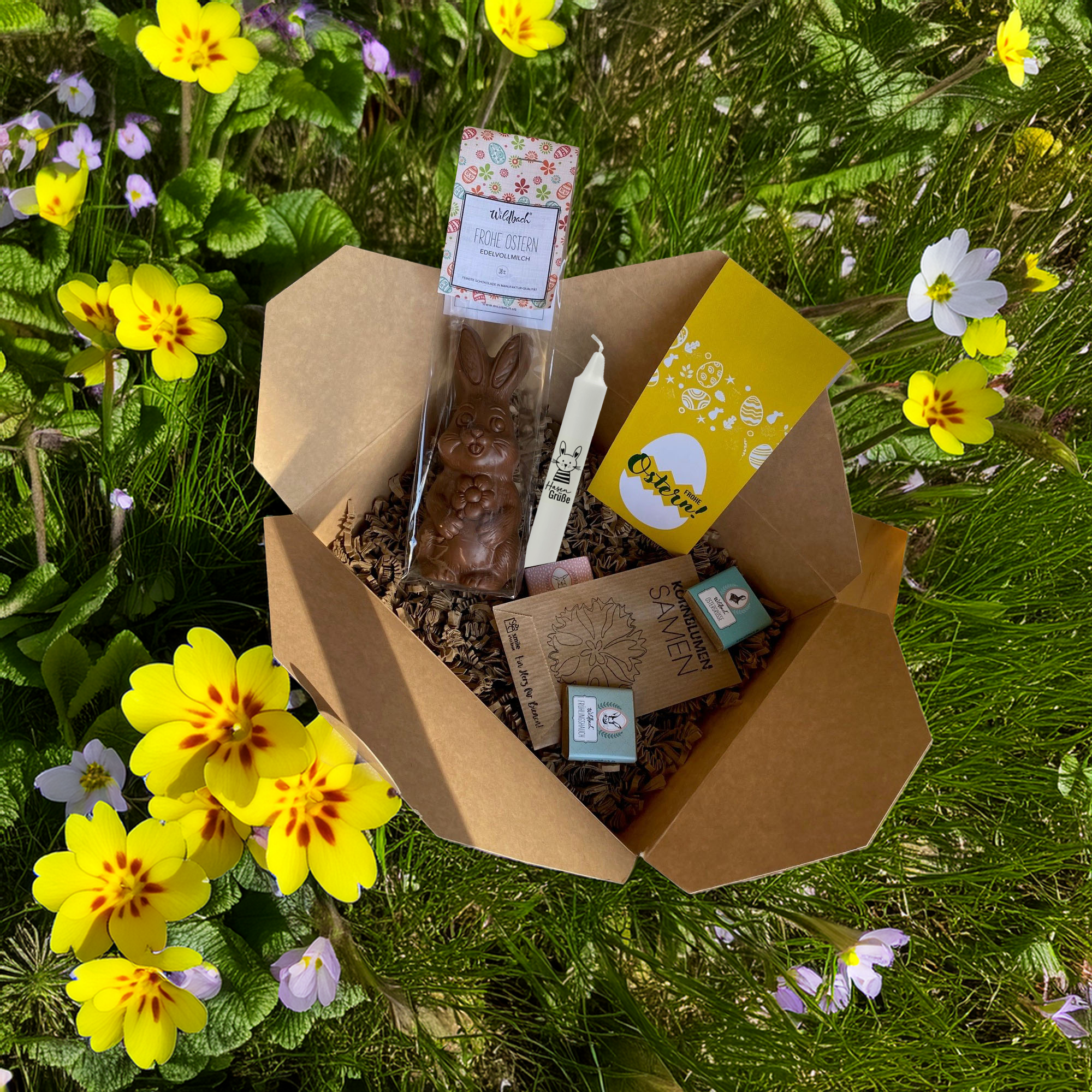 Osterbox für Kunden und Mitarbeiter mit Osterkerze, Schokohase, Schokotäfelchen und Blumensamen.