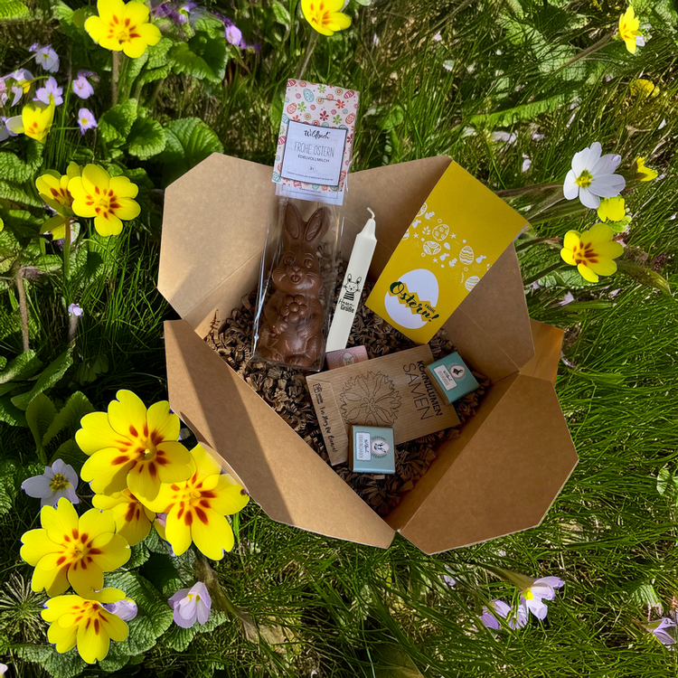 Osterbox für Kunden und Mitarbeiter mit Osterkerze, Schokohase, Schokotäfelchen und Blumensamen.