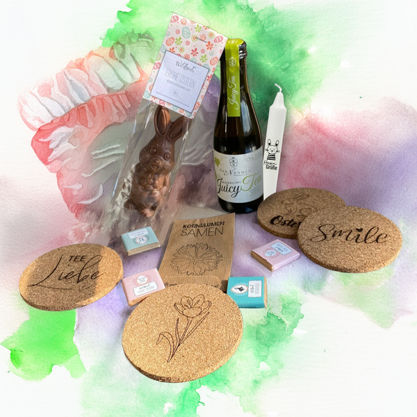 Osterüberraschung für Kunden mit Osterkerze, Schokohase, Schokotäfelchen, Juicy Tee, frühlingshaften Korkuntersetzern und Blumensamen. Auch ein perfektes Ostergeschenk für Mitarbeiter!