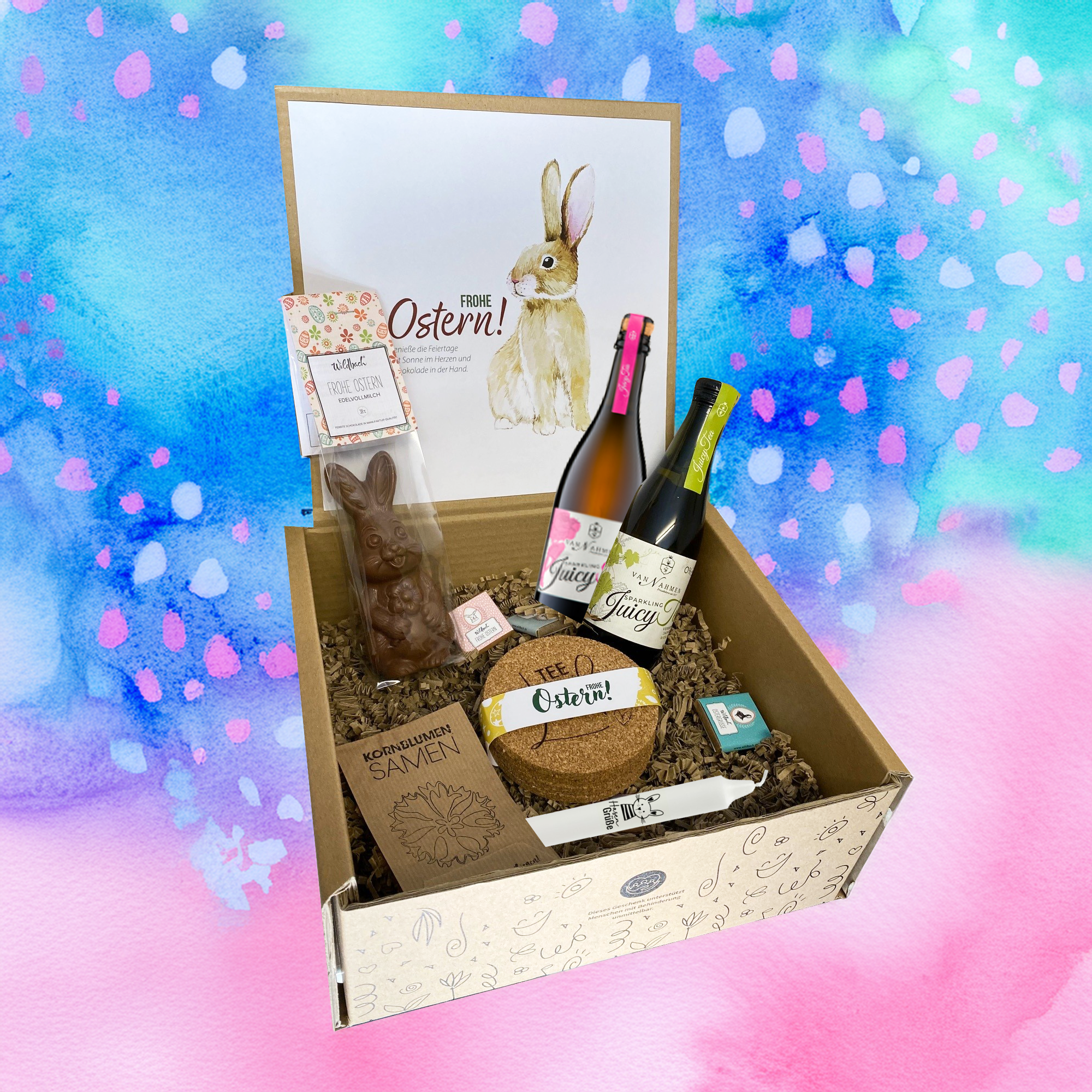 Osterüberraschung für Kunden mit Osterkerze, Schokohase, Schokotäfelchen, Juicy Tee, frühlingshaften Korkuntersetzern und Blumensamen arrangiert in Gecshenkbox. Auch ein perfektes Ostergeschenk für Mitarbeiter!